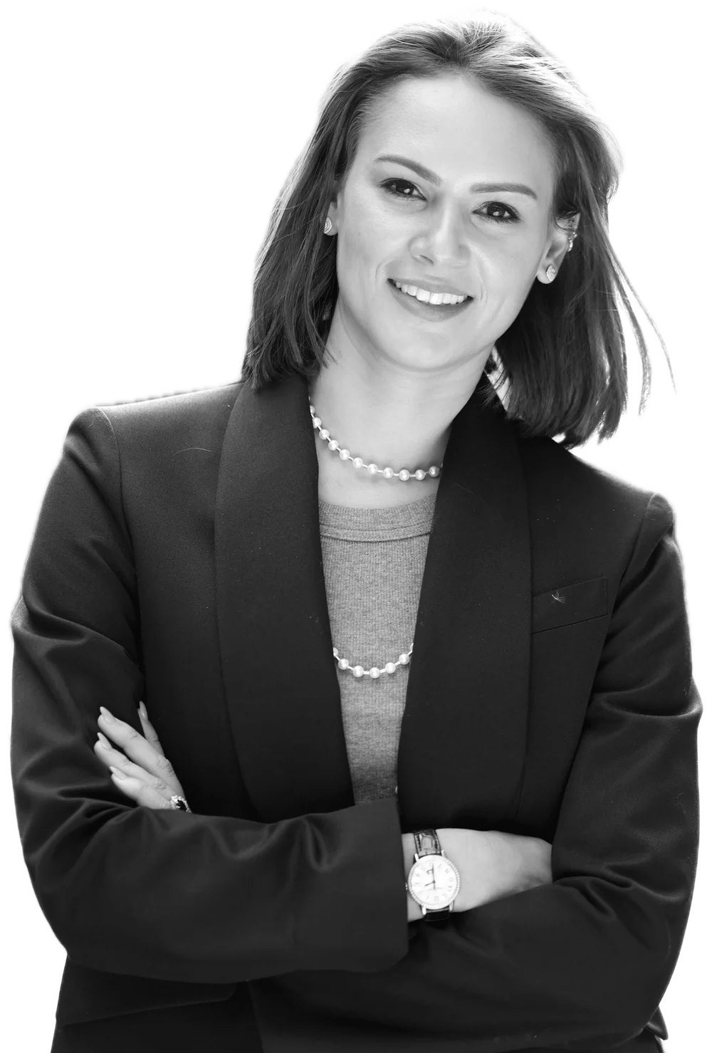 An executive smiles with her arms crossed.