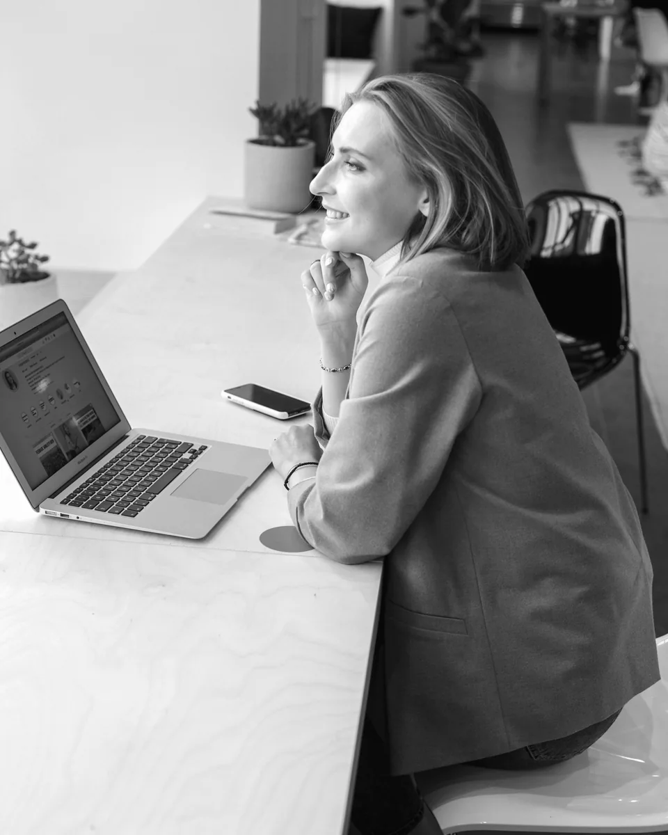 A manager seated at her desk looks out the window.